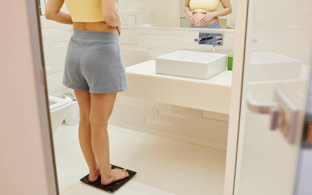 woman checking weight on weighing scale