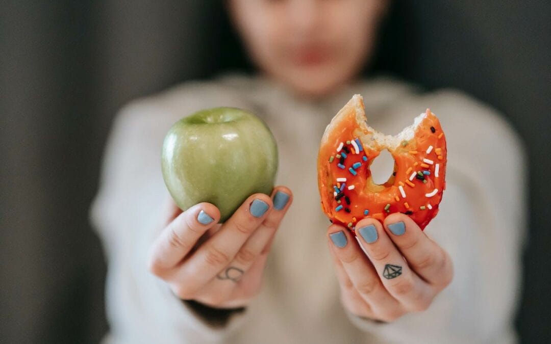 holding an apple and a donut